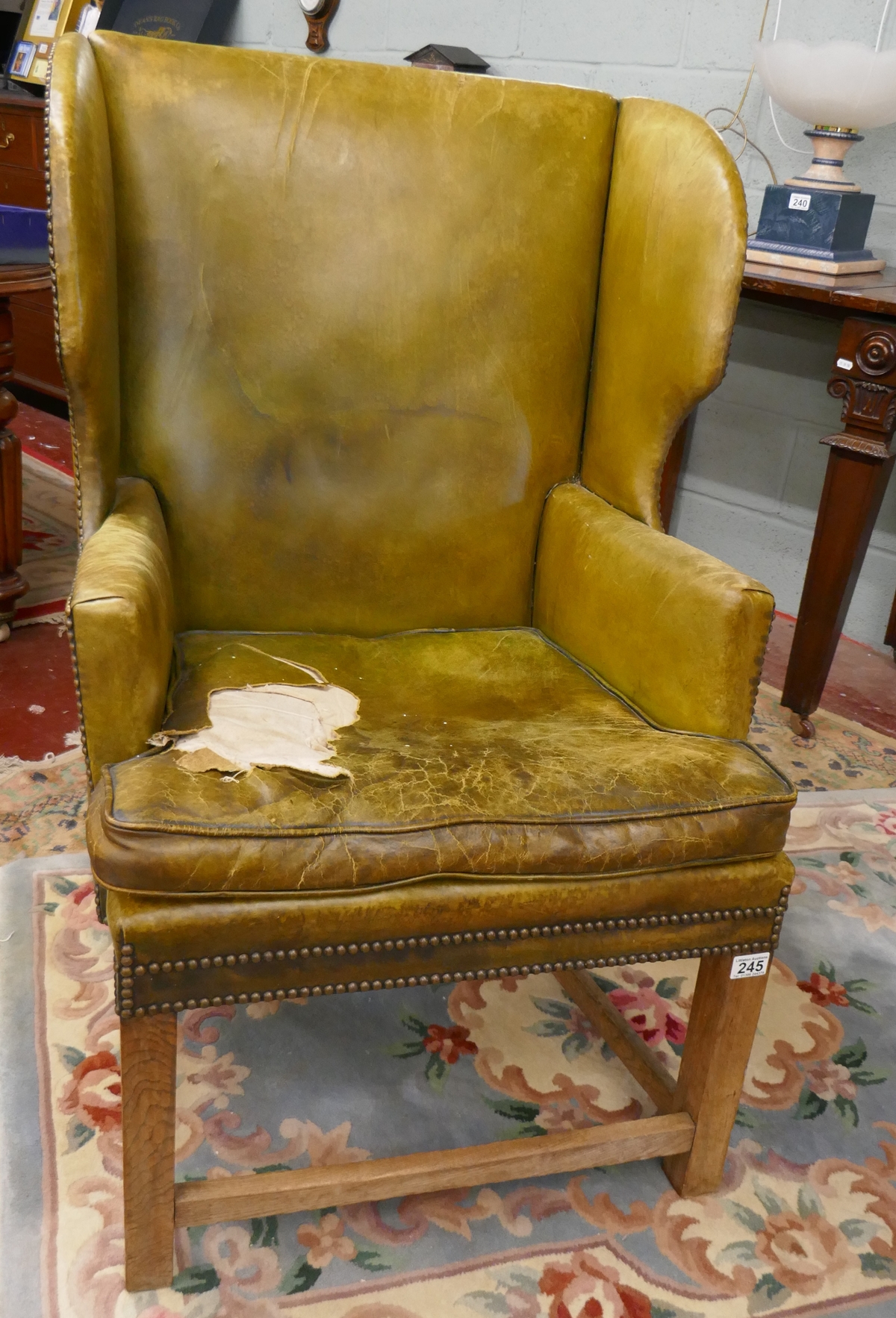 Green leather wing back armchair