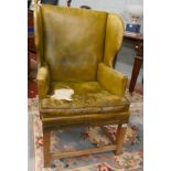 Green leather wing back armchair