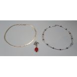 2 silver necklaces and pendant on chain