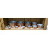 Collection of graduated copper saucepans
