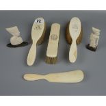 Ivory brushes and 2 small ivory figures