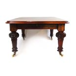 A Victorian mahogany extending dining table with a wind out mechanism incorporating three extra