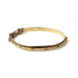 A 9ct gold hinged bracelet set with five small diamonds. Approx weight 14.1g, internal w. 6.