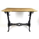 A 19th century cast iron pub table, the weathered wooden top on the black painted base, h. 93 cm, w.