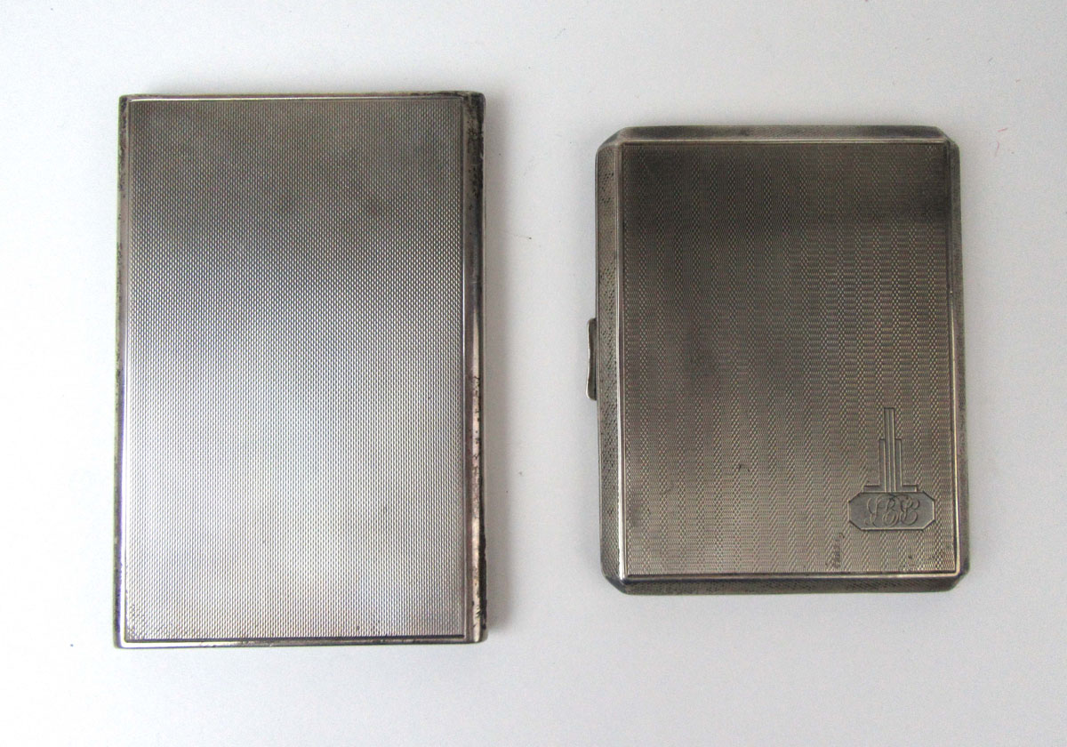 A George VI silver cigarette case by Asprey together with a similar George V silver cigarette case.