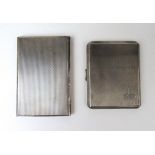 A George VI silver cigarette case by Asprey together with a similar George V silver cigarette case.