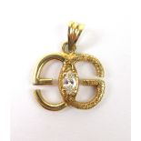 A yellow metal pendant in the form of a pair of entwined 'Gs',
