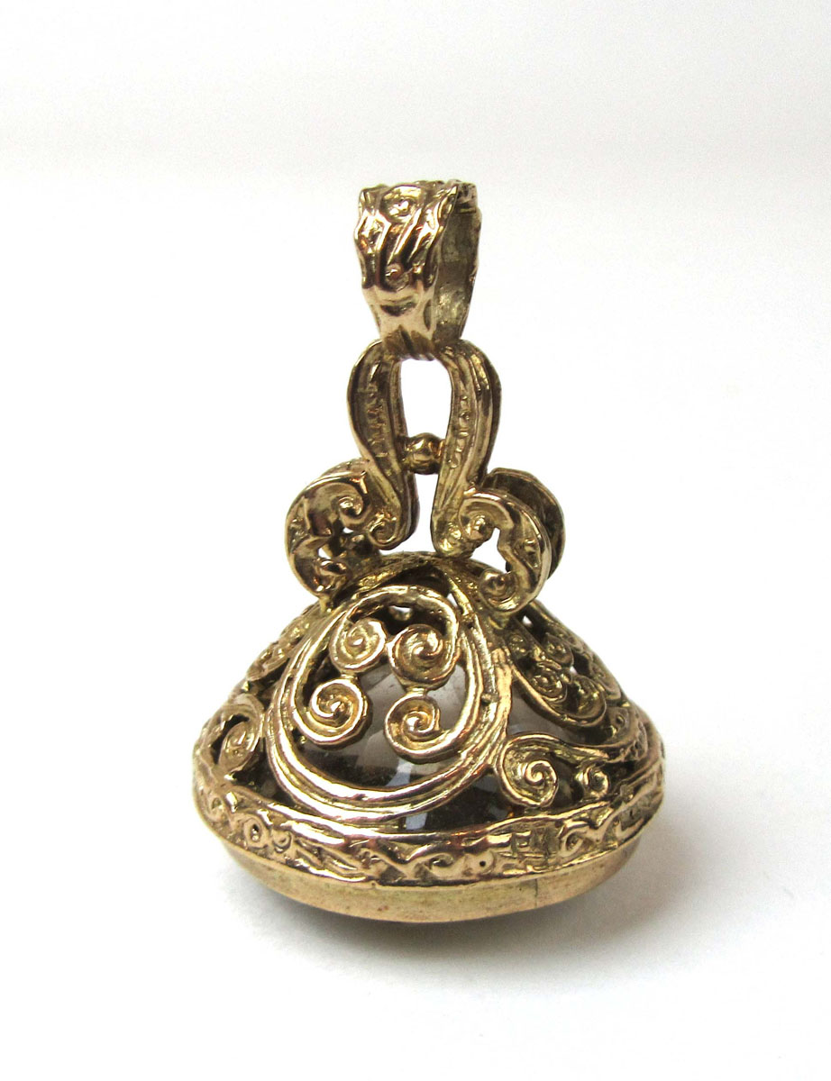 A 9ct yellow gold seal fob having an non-engraved smoky quartz stone set in an ornate mount.