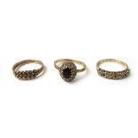 Three 9ct gold rings to include a two row keeper ring together with a garnet and paste cluster ring