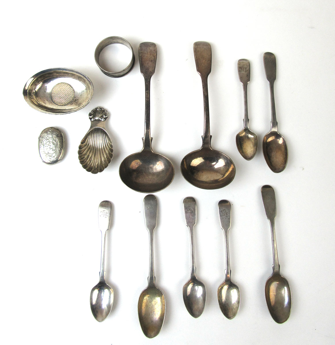 An assortment of silver and white metal items to include soup ladles, vesta case, caddy spoon,