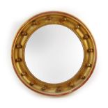 A Regency style giltwood convex mirror, the frame with applied spheres, dia.