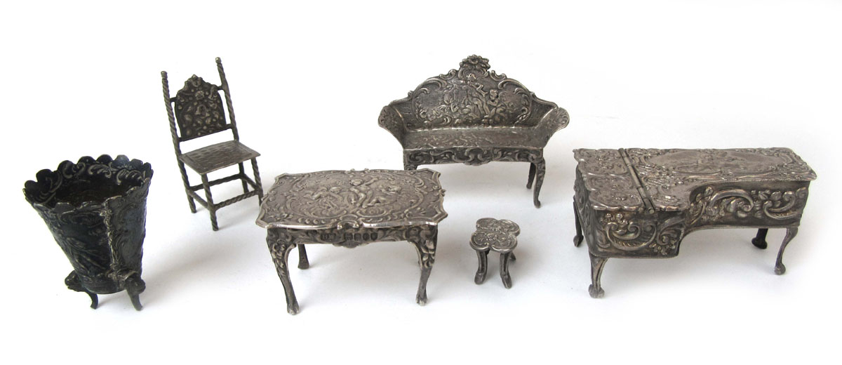 A selection of miniature silver and white metal dolls house furniture to include piano, settee,
