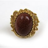 A yellow metal and red goldstone ring marked '750'. Approx weight 6.