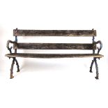 A late 19th century garden bench with naturalistic cast iron ends stamped 'Bristol Wagon Works', h.