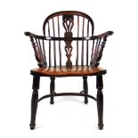 An early 19th century elm Windsor chair, the comb back with pierced splat on turned legs, h.