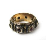 A yellow metal ring of Renaissance design set with seven small rubies. Approx weight 7.
