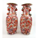 A large pair of 19th century Japanese imari baluster vases having pomegranate handles and dense