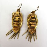 A pair of Victorian yellow metal buckle design earrings having applied leaf decoration and tassels.