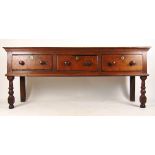 An 18th century oak dresser base, the top over three drawers on turned front legs, h. 78 cm, w.