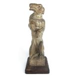 A carved oak newel post finial in the form of a dog modelled standing on its hind legs, h. 51.