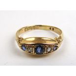 An Edwardian 18ct gold, sapphire and diamond ring of boat shaped form. Approx weight 2.5g.