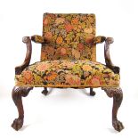 A George II walnut 'Gainsborough' chair upholstered in floral needlework fabric,