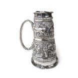 A late 19th century Indian white metal double measure having embossed tiger decoration.