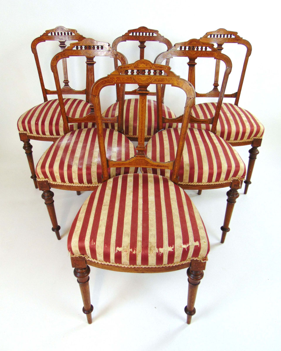 A set of six Edwardian walnut, amboyna, boxwood strung and marquetry dining chairs,
