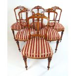 A set of six Edwardian walnut, amboyna, boxwood strung and marquetry dining chairs,