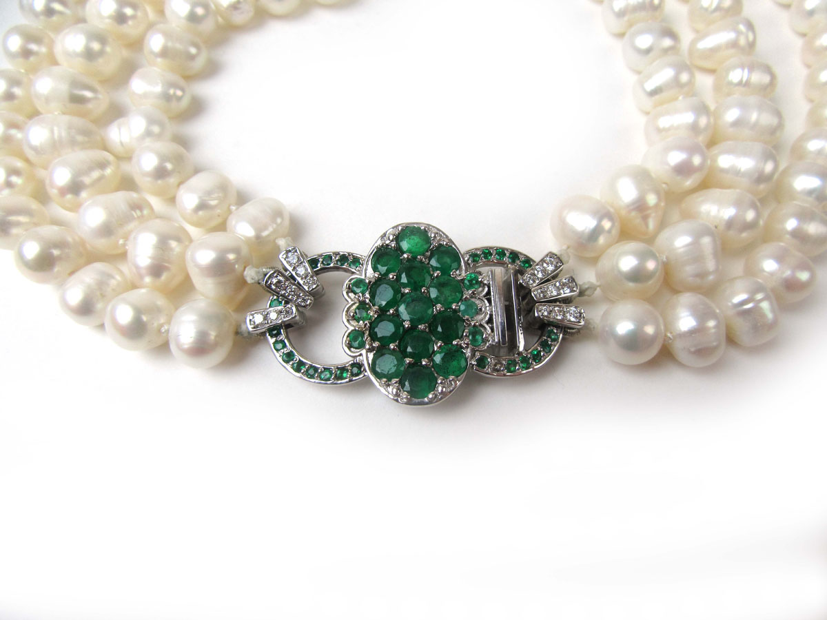A triple strand continuous cultured pearl necklace with an 18ct white gold clasp set with emeralds - Image 2 of 3
