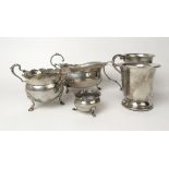 An assortment of silver items to include two mugs, a sauce boat, a cream jug and a salt.