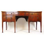 A George III mahogany and boxwood strung serpentine front sideboard,