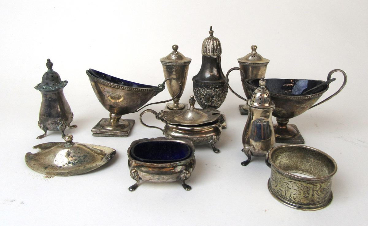 An assortment of silver cruet items to include shakers, open salts etc. Various hallmarks.