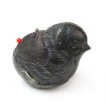 An Edwardian silver pin cushion in the form of a chick.