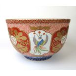 A large Japanese Meiji period imari bowl decorated with bird and floral motifs.