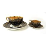 An early 20th century Coalport quatrefoil shaped cabinet cup and saucer having gilt decoration on a