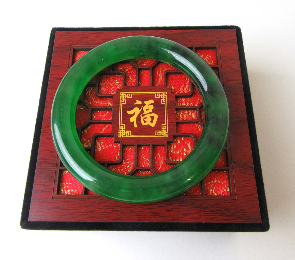 A dark green jade bangle, internal diameter approx. 5.