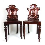 A pair of Victorian mahogany hall chairs,