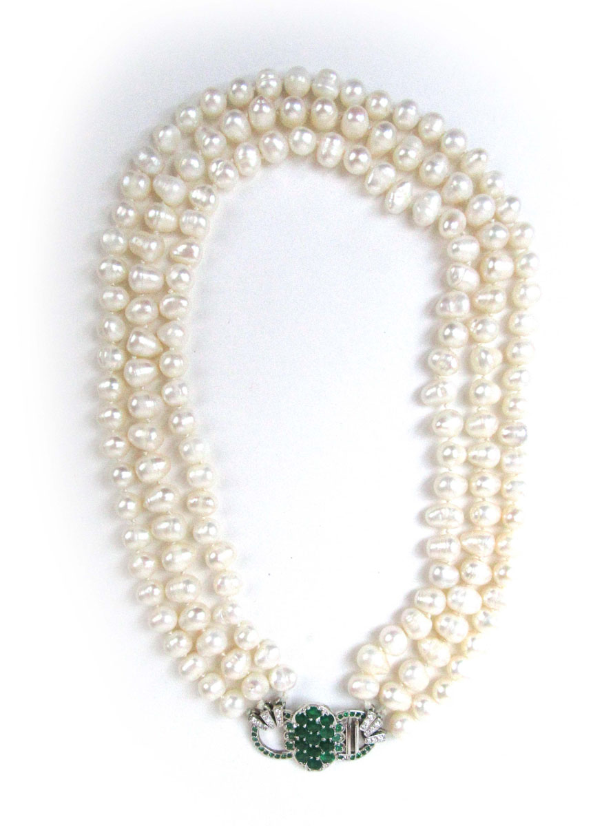 A triple strand continuous cultured pearl necklace with an 18ct white gold clasp set with emeralds