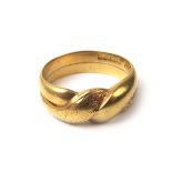 An 18ct gold ring of twisted form with partial engraving. Hallmarked for London possibly 1911.