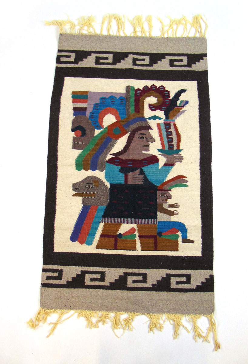 A handwoven South American rug, the border surrounding a warrior in headdress,