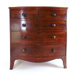 A 19th century mahogany bow front chest of two short over three long drawers with turned knob
