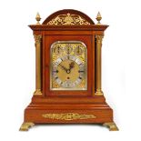 A late 19th century oak cased bracket clock, the case with domed roof, applied pineapple finials,