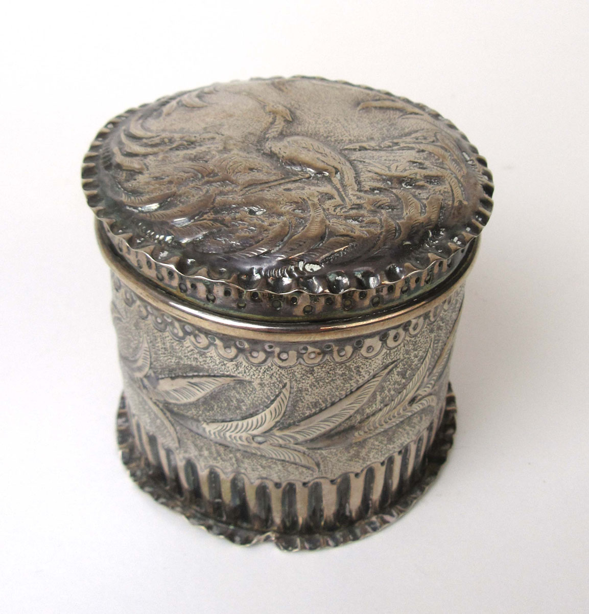 A small Victorian silver tea caddy having embossed naturalistic decoration. - Image 2 of 2