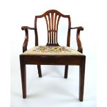 An 18th century elm open arm chair,