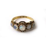 A Victorian 18ct gold and moonstone ring, the five cabochon stones set in an ornate mount.