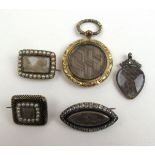 A group of five late Georgian and early Victorian yellow metal mourning brooches and pendants to