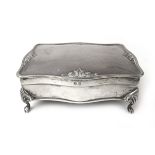 A George V silver jewellery box, the rectangular body supported on paw feet.