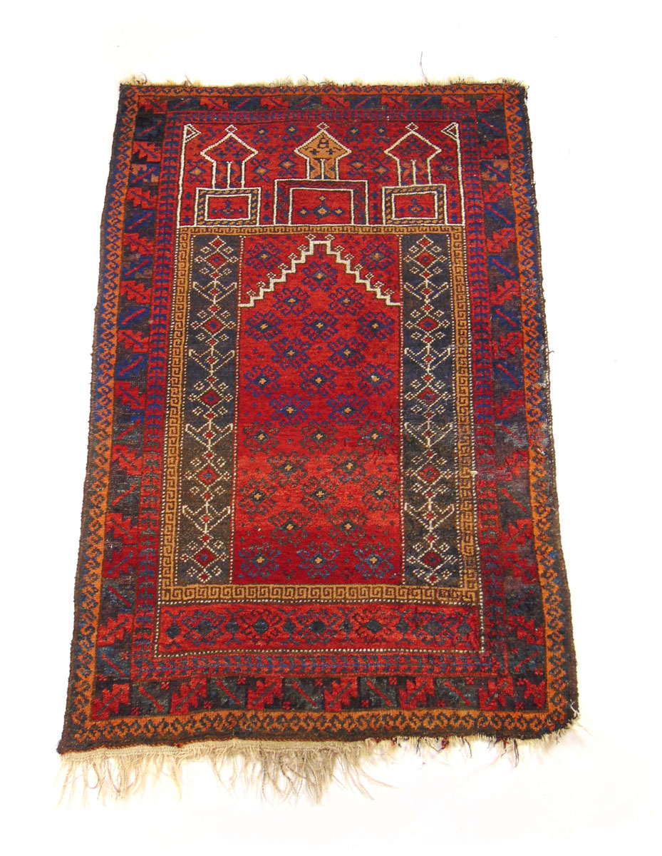 A handwoven Turkish prayer rug, the triple line border enclosing the red ground niche,