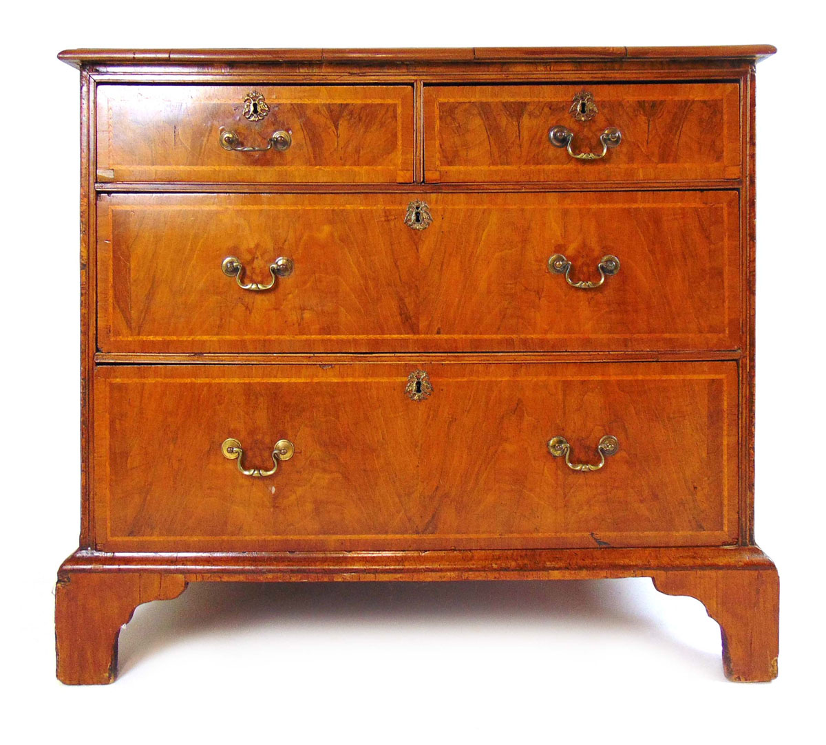 An early 18th century and later walnut and banded chest of two short over two long drawers on